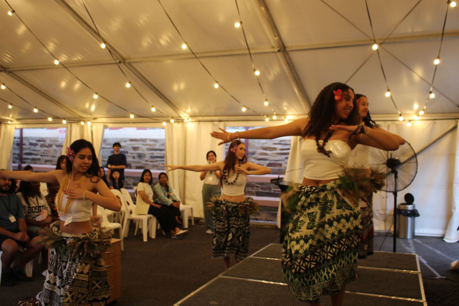 Dancers performing under the fairy lights in the marquee